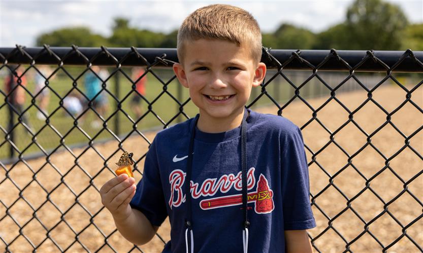 Students smile while releasing butterflies outside